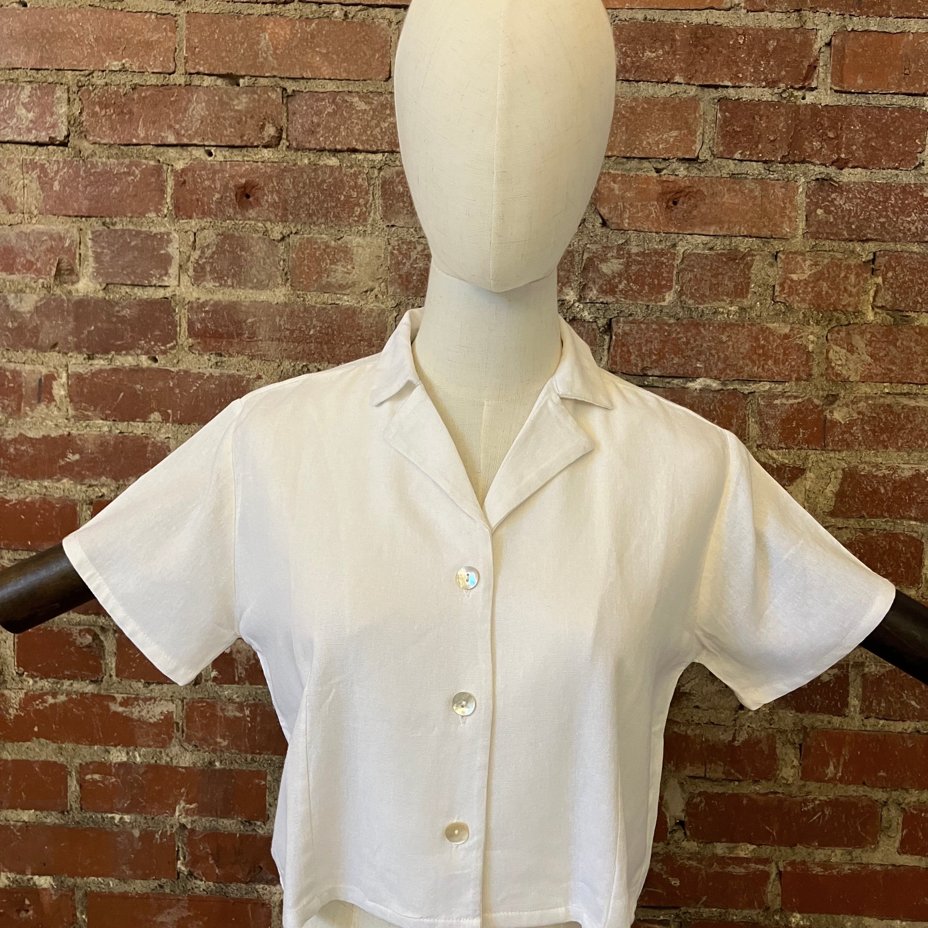 White shirt on a mannequin against a brick wall