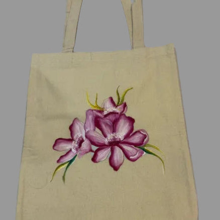 Beige tote bag with a pink floral design on a white background