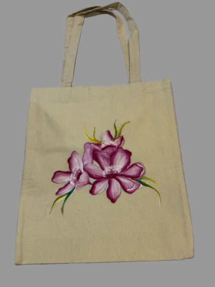 Beige tote bag with a pink floral design on a white background