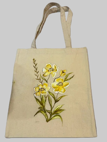 Beige tote bag with yellow floral design on a light background